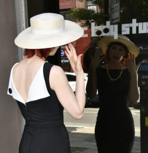 West Village Model Karen Rempel adjusts her hat in the window of Electric Lady Studios