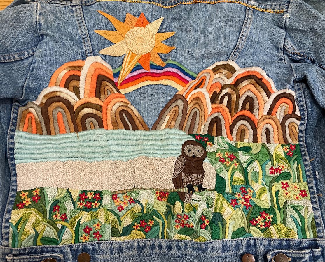 Jean jacket featuring an embroidered landscape by Joan Bedor