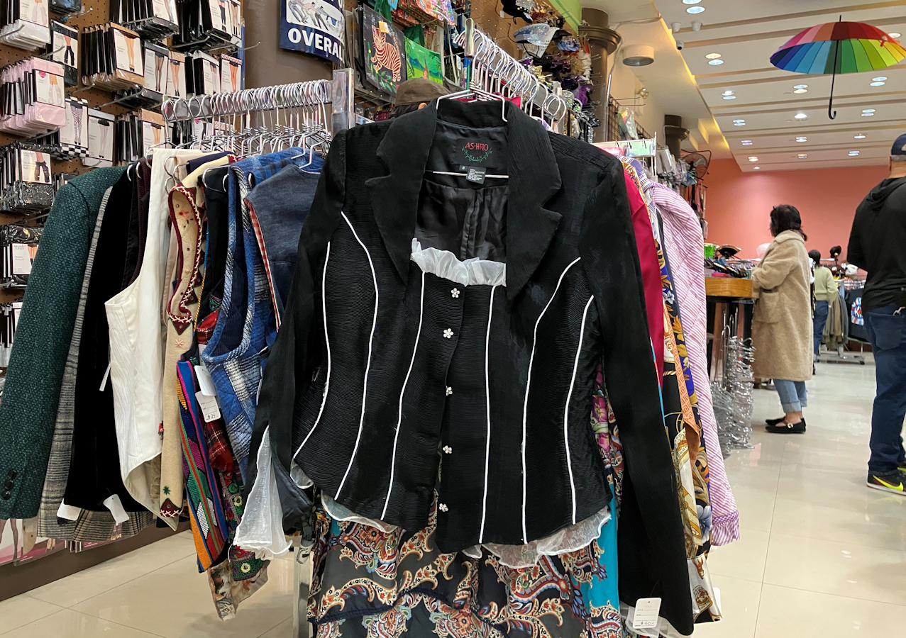 Black jacket with white piping, pearl flower buttons, and lace 