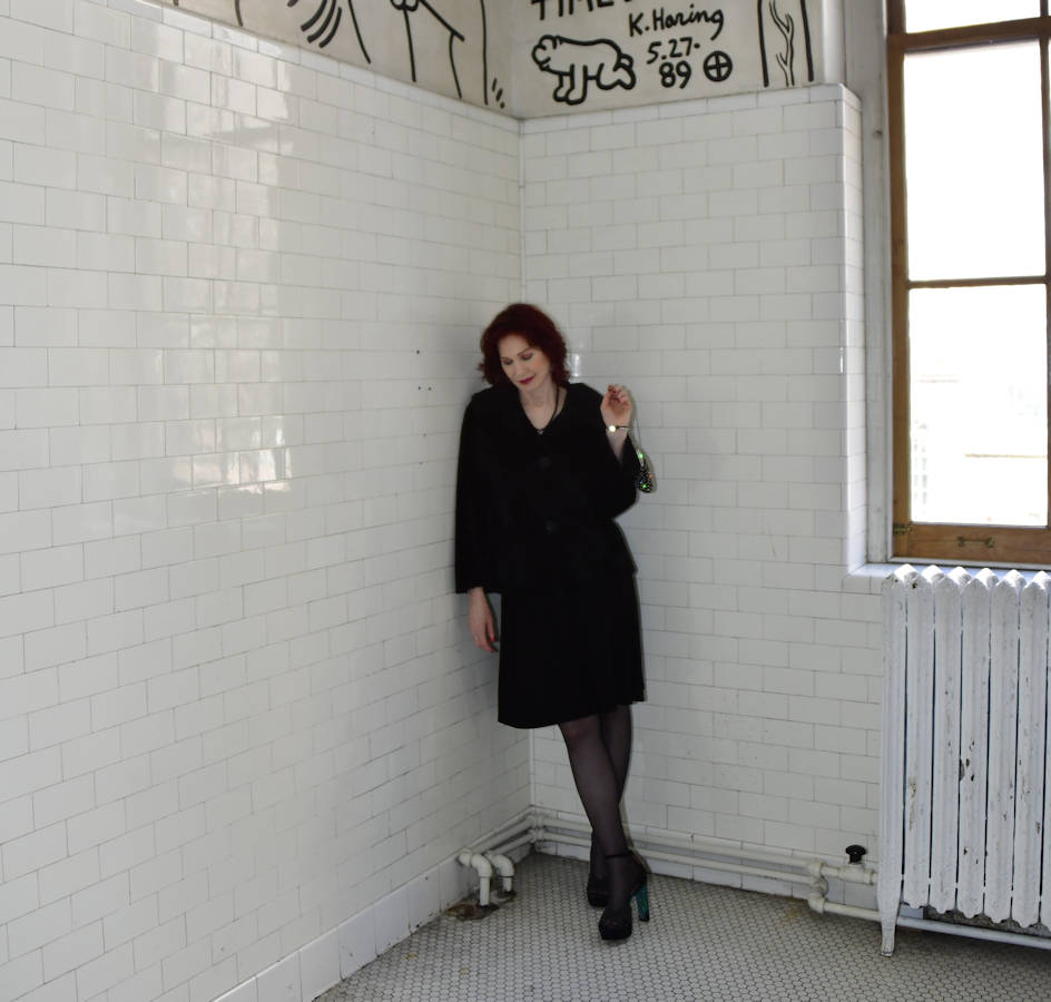 4. Karen Rempel admires the wrap-around mural in the Keith Haring Bathroom at the LGBT Community Center on W. 13th St.